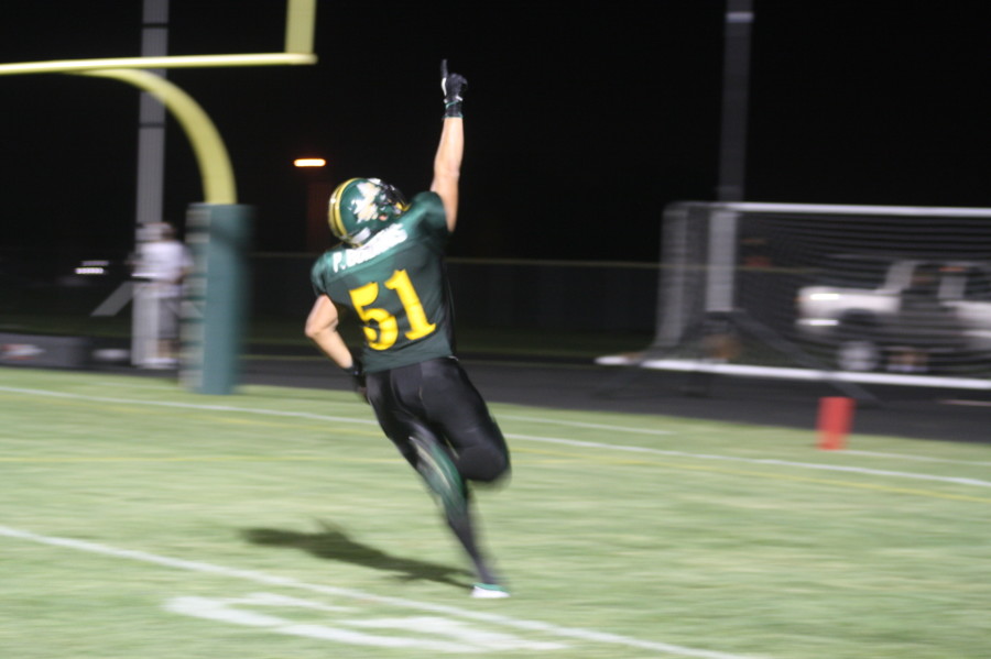 At the Loyalty Day football game, senior Paul Boidanis points to the sky after he scores a touchdown. He said he does this because he plays for the boys who died this past summer. Photo by Jessica Hoffen.