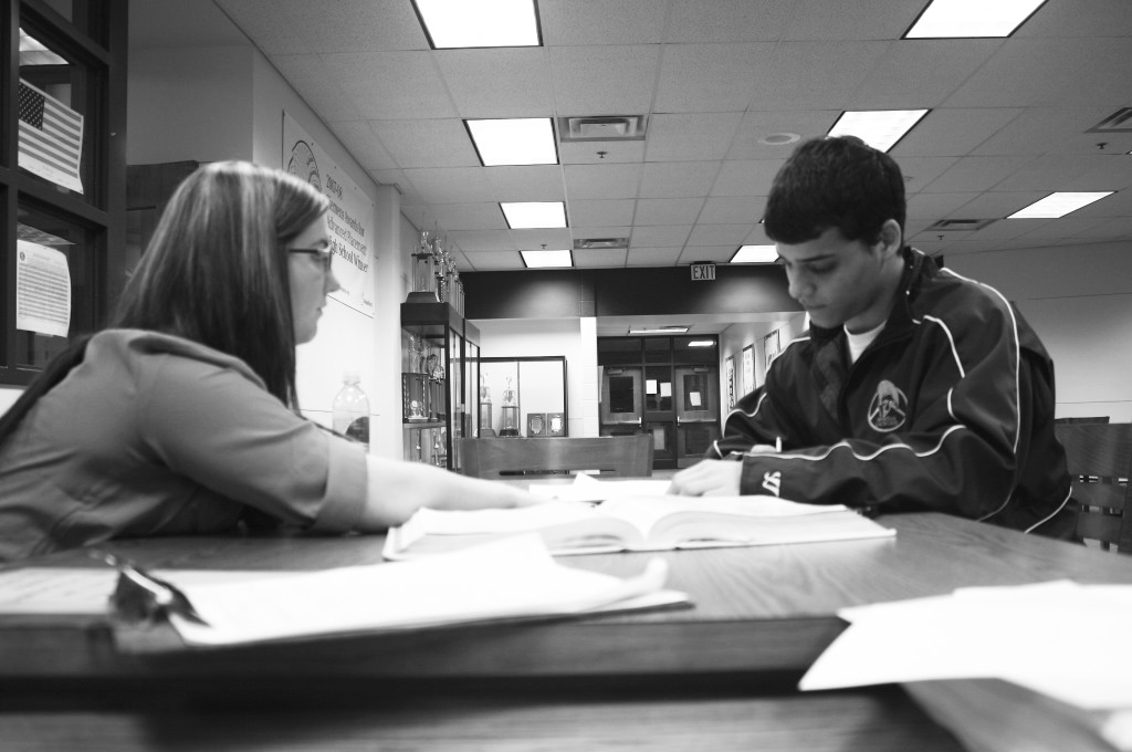 Math teacher Sara Nichols helps junior Jake Verne with math problems in the Math Resource Center after school. In 2010, the state of Illinois adopted the CCSS for English language arts and math curricula, resulting in plans to integrate statistics and probability into math classes.