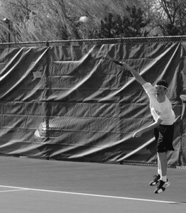 Sophomore Will Sauser serves in a singles match against Niles North on April 30. Sauser won the match 6-0, 6-0 while the team also went on to win the meet. Photo by Matt Coleman.