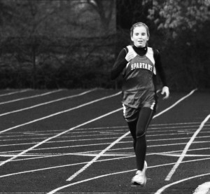 Sixteen season varsity athlete Valerie Bobart competes in the two mile run at the conference meet on May 3. Bobart placed second in the race with a time of 11:59 minutes. Photo by Grace Ruklick.