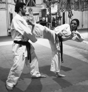 Senior Sammi Weinberg performs a roundhouse kick against training partner Jeff Mason. This was one of the skills Weinberg competed with at the Maccabiah Games. Photo by Lauren Sulkowski.