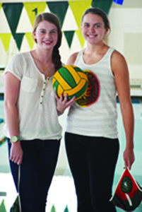 Junior Lindsey Fraser (left) and Senior Kerry Goodspeed pose in front of the pool. They competed in international water polo this past summer. Photo by Jake Golbus.