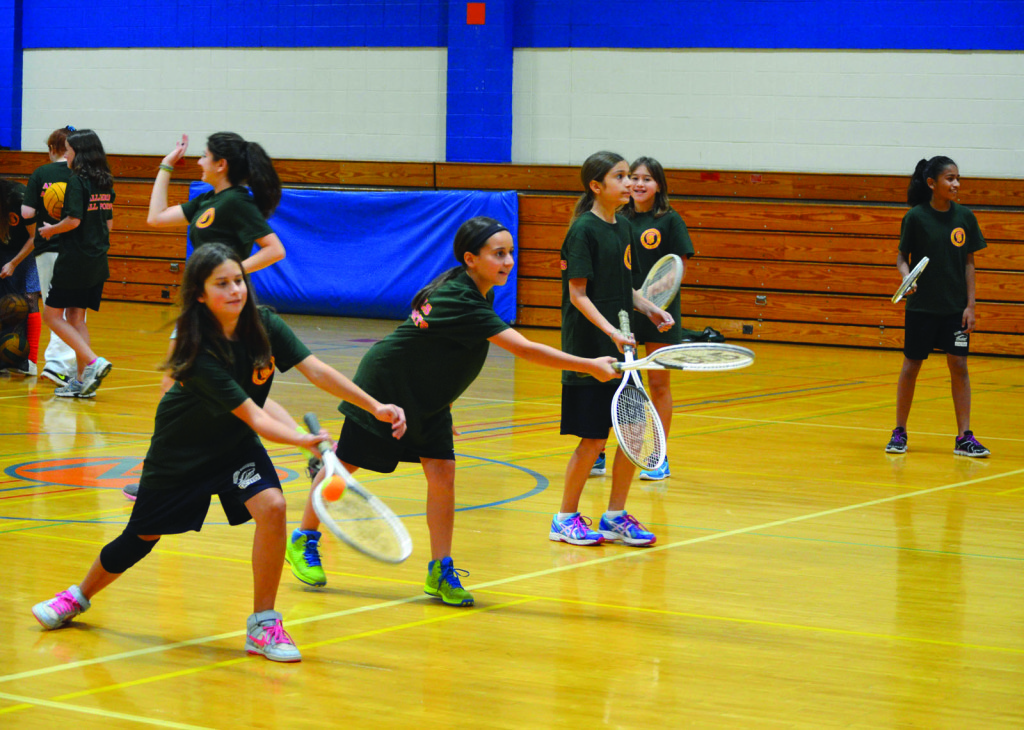 Participants of an “All Girls, All Sports” clinic practice hitting tennis balls back and forth during a clinic held at Maple Middle School on Oct. 17. The program has been in existence for two years and founder Danielle Fluegge hopes to continue to increase participation each year. Photo by Gabe Weininger.
