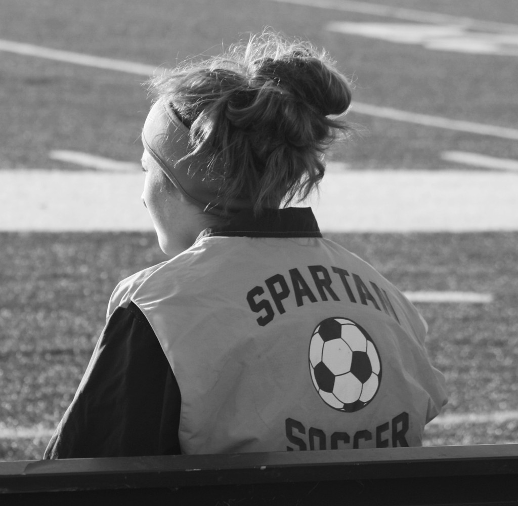 Junior Morgan Adducci cheers for her team in a game against Resurrection on March 19. Glenbrook North won the game 5-0. Photo by Shayna Lutz.