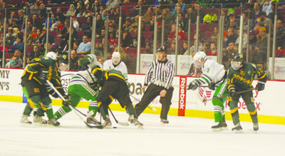 GBN players fight for the puck during the AHAI State Championship at the United Center.
The team lost 1-2 against New Trier Green. Photo by Allan Dontsis.