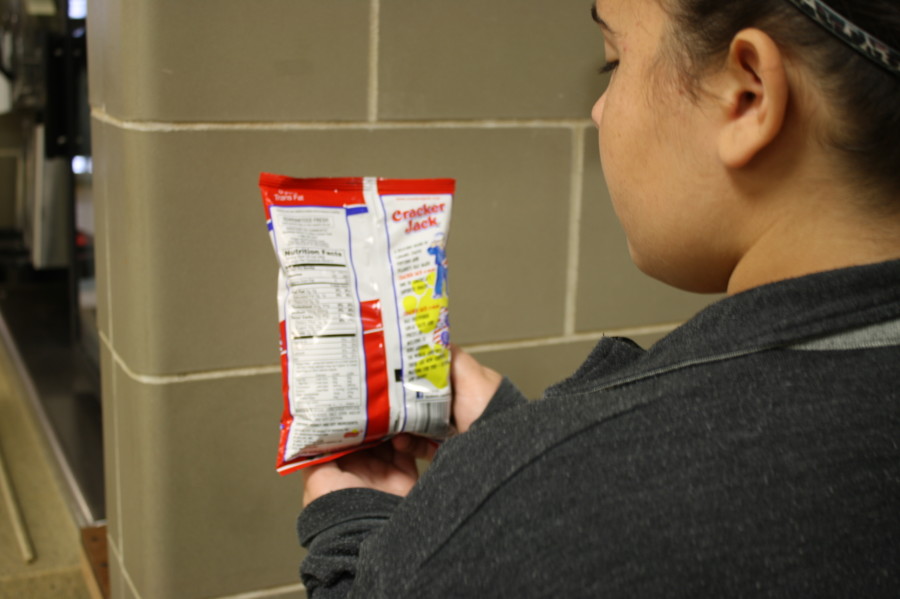 Cracker Jack, sold in the cafeteria, provides nutritional information for every serving of popcorn on the label. There are three one-half cup servings per one bag. Photo illustration by Jenna Magill.