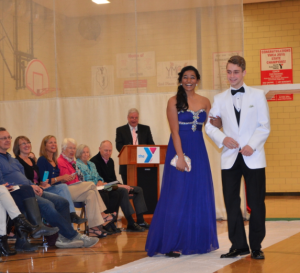 Senior Jeevana Pakanati (left) and junior Ryan Goldsher pose on the runway at the Prom Fashion Show. Prom-inspired clothing was modeled by 43 high school students. Photo by Anna Hirshman
