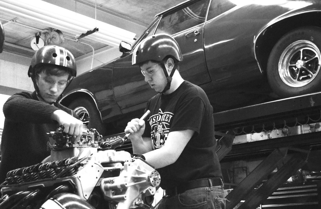 Juniors Billy Demos (left) and Thomas Kozel take apart an engine during practice. Both traveled to Indianapolis with three other teammates to compete in nationals in December. Photo by Gabe Weininger