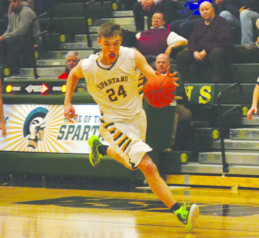 Senior Pat Hamilton dribbles down the court on Jan. 13 in a 63-46 win over Wheeling. As of Jan. 27, he is shooting 51 percent on two-point field goals, 54 percent on three-point field goals and 90 percent on free throws. Photo by Alan Dontsis
