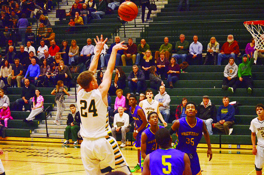 Senior Pat Hamilton shoots against Waukegan in a 66-55 Spartan victory on Dec. 2. Waukegan is scheduled to leave the Central Suburban League after the 2015-16 school year to join the North Suburban Conference. This will mark the first time since the 1991-92 school year, when Niles North joined the CSL, that a new school will be added to the conference. Photo by Gabe Weininger