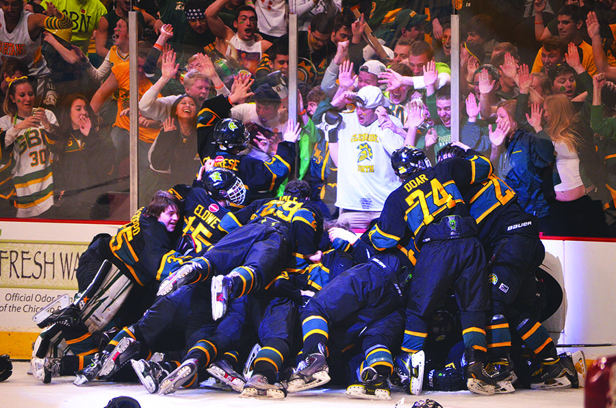 The hockey team celebrates its overtime win over Benet in the Blackhawk Cup state championship game at the United Center on Sunday, March 22. Junior Joey Day scored the game-winning goal to give the Spartans their first state championship since 2008 and fifth in the program’s history. Photo by Gabe Weininger