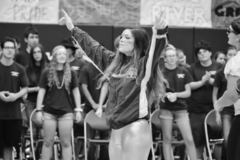 Senior Maddie Grouzard rallies the crowd with Down to the River Boys during the Loyalty Day assembly. The group attends various sporting events and assemblies to encourage fan spirit. Photo by Meghan Cruz.