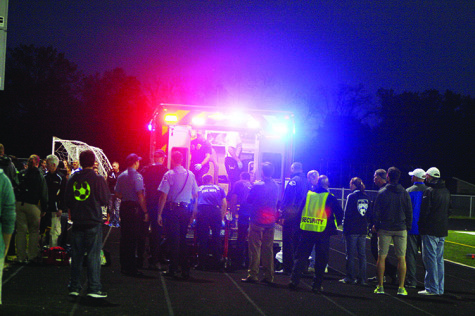 Emergency officials lift senior Tim Schwall into an ambulance before the Glenbrook North vs. Highland Park football game on Oct. 2. Schwall sustained a concussion after being chased by a Highland Park student. Photo by Emily Chwa  