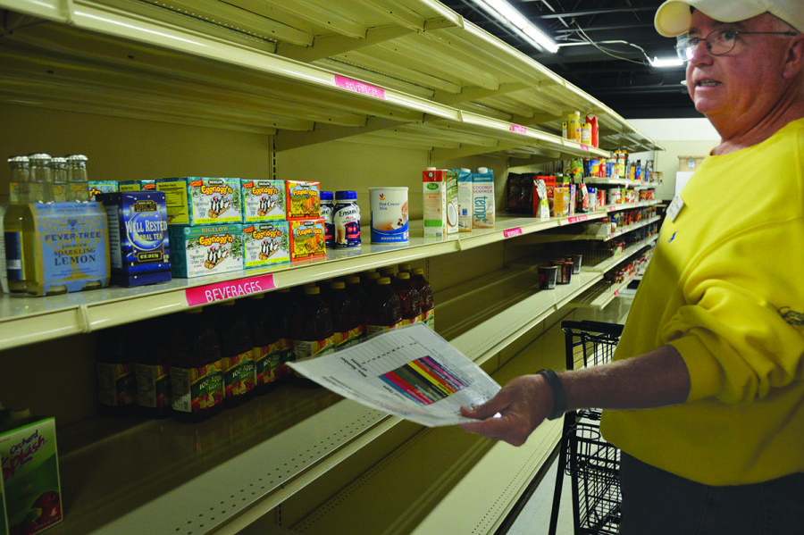 Ray Dempsey, a volunteer at the Northfield Township Food Pantry, stocks shelves. During last year’s food drive, Glenbrook North did not bring in as many donations as SA Board had hoped. Photo by Meghan Cruz