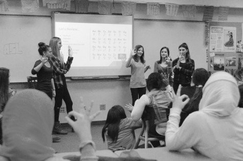 American Sign Language Club board members teach the ASL alphabet to students at their club meeting on Nov. 10. The club members also answered true or false questions regarding misconceptions about Deaf Culture. Photo by Meghan Cruz.