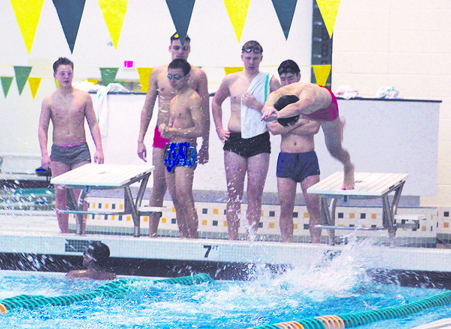 Junior Tural Erel (right) practices starting off the diving block for his 200m freestyle relay on Dec. 3. The team’s first meet was on Dec. 4 against Lyons, in which the Spartans lost 115-70. Senior Mark Schneider won both the 100m and 200m freestyle races, finishing with times of 48.7 and 1:47.4, respectively. Photo by Alec Mawrence.