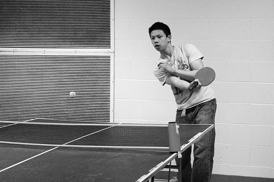 Sophomore Matthew Eng follows through on a forehand while playing a match during a pingpong meeting on March 15. Intramural pingpong, started by Eng, meets every Monday after school in the cafeteria. Photo by Hope Mailing.