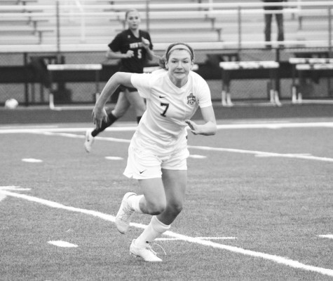 Freshman Samantha Cramin sprints toward the ball at a home game on May 9. Cramin is one of two freshmen who were moved up to the varsity team at the beginning of the season. Photo by Chloe Carroll.  