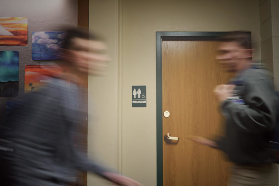 Students walk past the gender-neutral bathroom, which is located across the SAC. The new district policy ensures students have access to the restroom that corresponds to their consistently expressed gender identity. Photo by Richard Chu