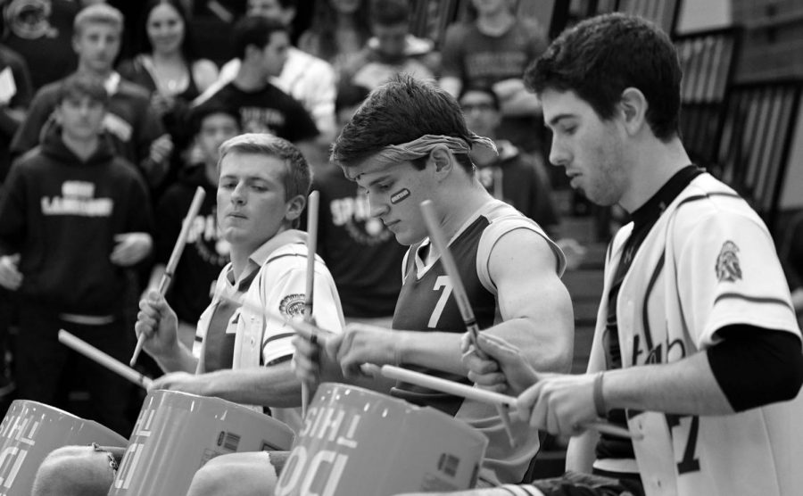Seniors Daniel Spencer, Sam Heydt and Ben Harkey (left to right) play at their last performance together during the 2018 Pride Assembly. The group has been performing together since eighth grade, and they have played in Glenbrook North assemblies and Variety Shows. Photo by Richard Chu