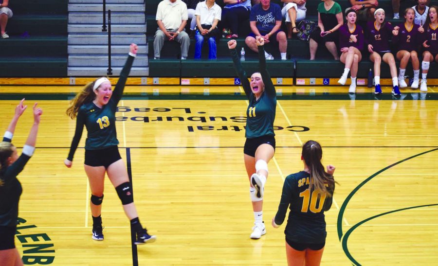 Junior+Casey+Brown+%28center%29+celebrates+with+her+teammates+after+a+point+is+scored+against+Loyola+Academy+on+Aug.+29.+This+has+been+Brown%E2%80%99s+first+year+with+the+Spartans%2C+helping+them+to+a+record+of+12-5+as+of+Sept.+24.+Photo+by+Grace+Chatas
