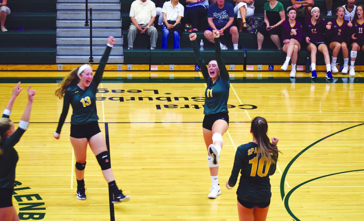 Junior Casey Brown (center) celebrates with her teammates after a point is scored against Loyola Academy on Aug. 29. This has been Brown’s first year with the Spartans, helping them to a record of 12-5 as of Sept. 24. Photo by Grace Chatas