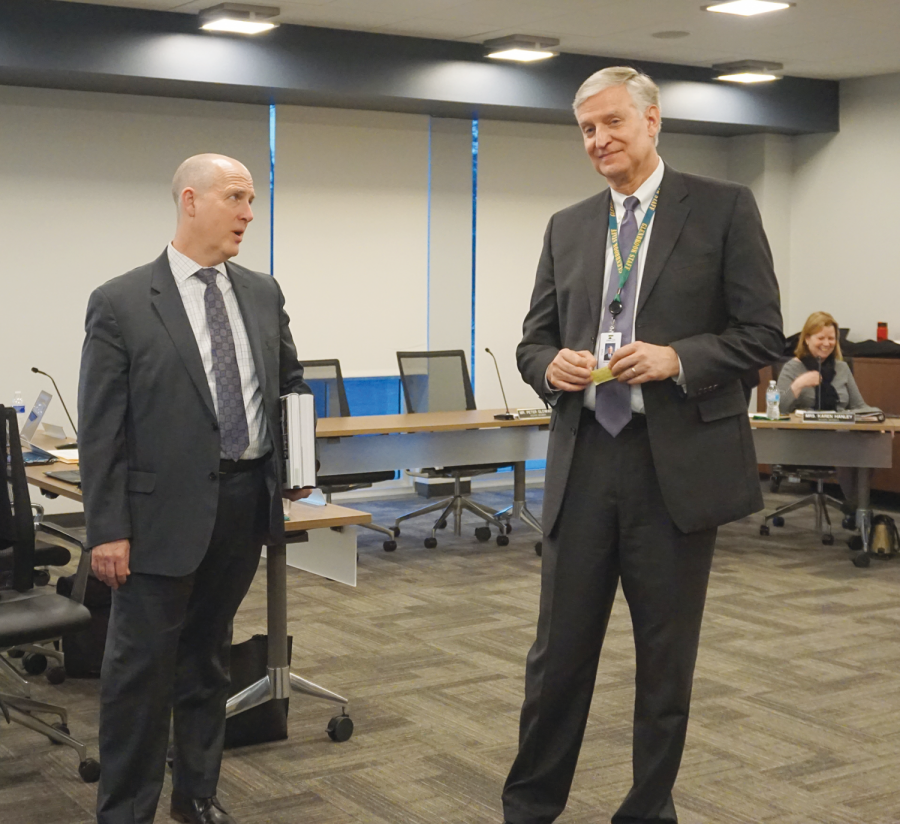 At+a+District+%23225+board+meeting%2C+newly+hired+superintendent+Charles+Johns+%28left%29+and+current+superintendent+Mike+Riggle+exchange+greetings.+Johns+is+scheduled+to+assume+this+position+on+July+1.+Photo+by+Andreea+Sabau