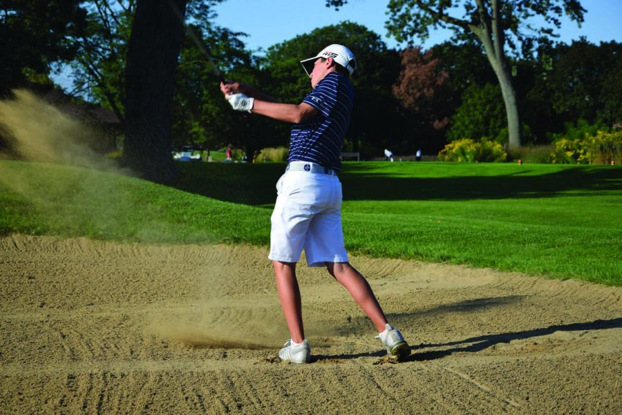 Freshman Jason Gordon shoots from a sand trap at Sportsman’s Country Club at practice on Friday, Sept. 6. Gordon was one of two freshmen chosen to play on the varsity team this year. Photo by Natalie Sandlow