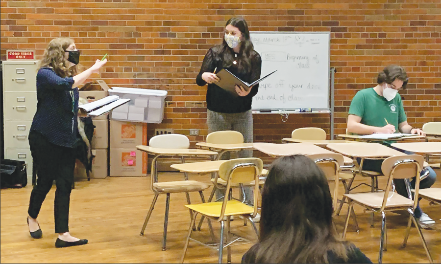 During a rehearsal on March 17, sophomore Leah Popovskiy and choir teacher Kelsey Nichols work on blocking for the part of Alice Beineke. “The Addams Family” was selected as this year’s Glenbrook musical in part because it had a new quarantine edition with a script adapted to COVID-19 regulations. Photo by Alyssa Sanchez