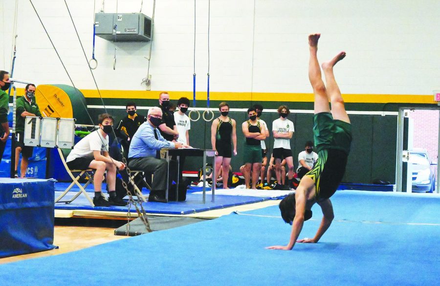At+a+varsity+boys+gymnastics+meet+against+Glenbrook+South+on+April+6%2C+sophomore+Sam+Diaz+performs+his+floor+routine.+While+this+meet+was+held+in+person%2C+girls+gymnastics+and+bowling+teams+participated+in+virtual+meets+throughout+their+seasons%2C+which+required+them+to+compete+at+locations+separate+from+their+opponents.+Photo+by+Saruul-Erdene+Jagdagdorj