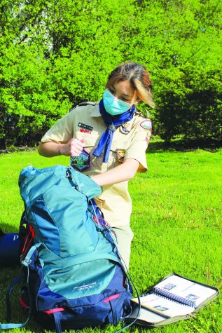 Sophomore Felicia Pace unpacks her backpack after a camping trip with Troop 64G. Pace started the troop with her father after Scouts BSA started welcoming girls and boys to join. Photo by Audrey Gottschild