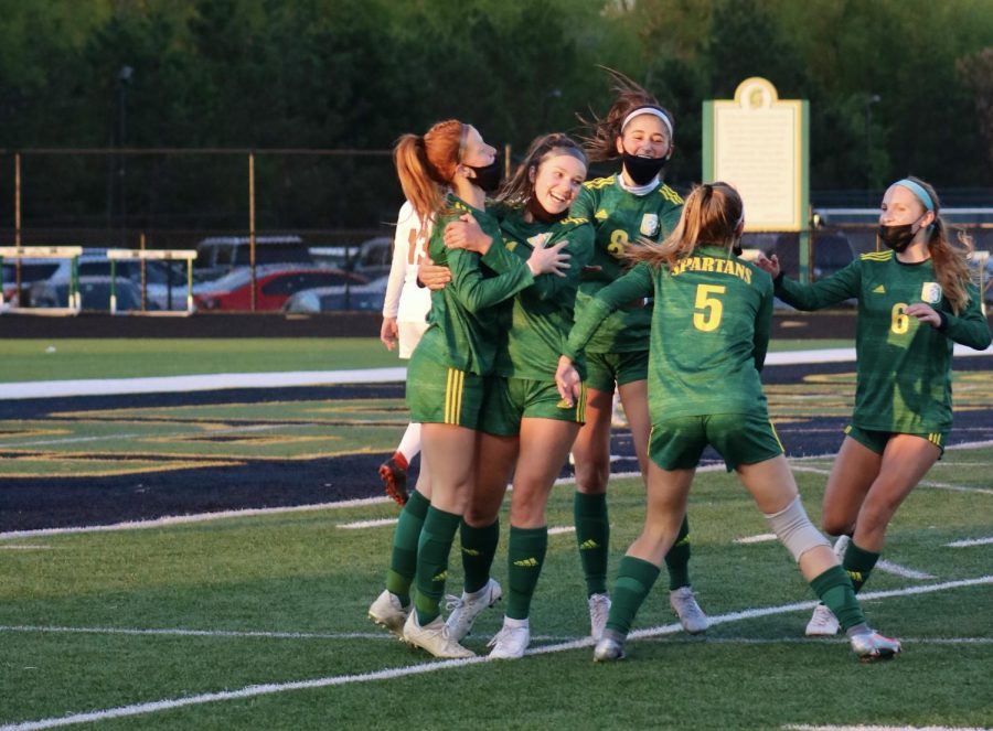 After scoring a goal against Evanston to tie the game 1-1, junior Margy Porta (far left) celebrates with her teammates on May 7. The final score was 2-2, and as of May 21, the team has a record of 9-1-3. Photo by Sarah Boeke