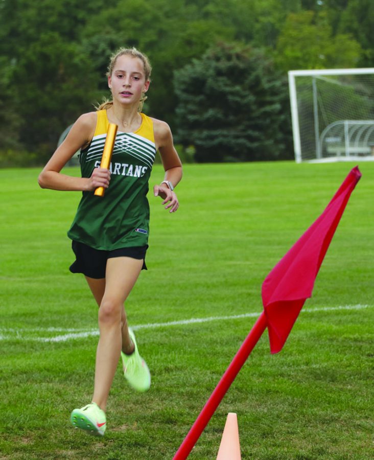 Freshman Juliet Frum races by the soccer fields on Aug. 31 in a dual meet against Glenbrook South. This season, Frum broke the program record for best girls cross country finish at state. Photo by Alex Garibashvily 