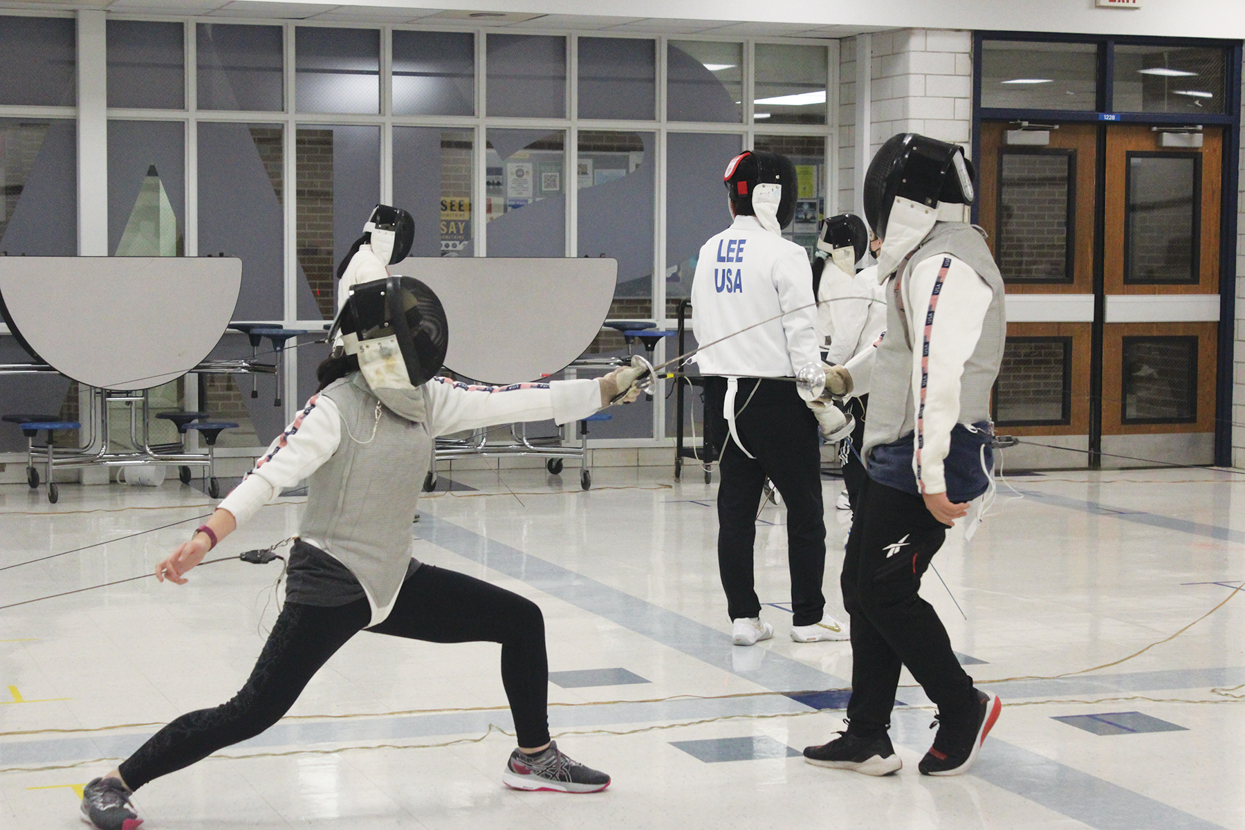During Fencing Club, which has members from Glenbrook North and Glenbrook South, GBS junior Claire Mui (left) works on skills. A new club proposal process intends for students to be purposeful when creating clubs. Photo by Claire Satkiewicz