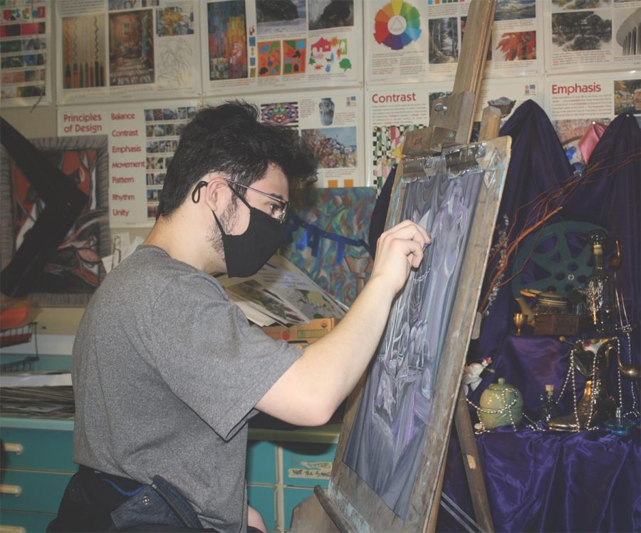 During senior Foster Seifert’s art class, he draws a still life picture. In the fall, the artwork of recent graduates is selected for the collection of pieces displayed around the school. Photo by Claire Satkiewicz
