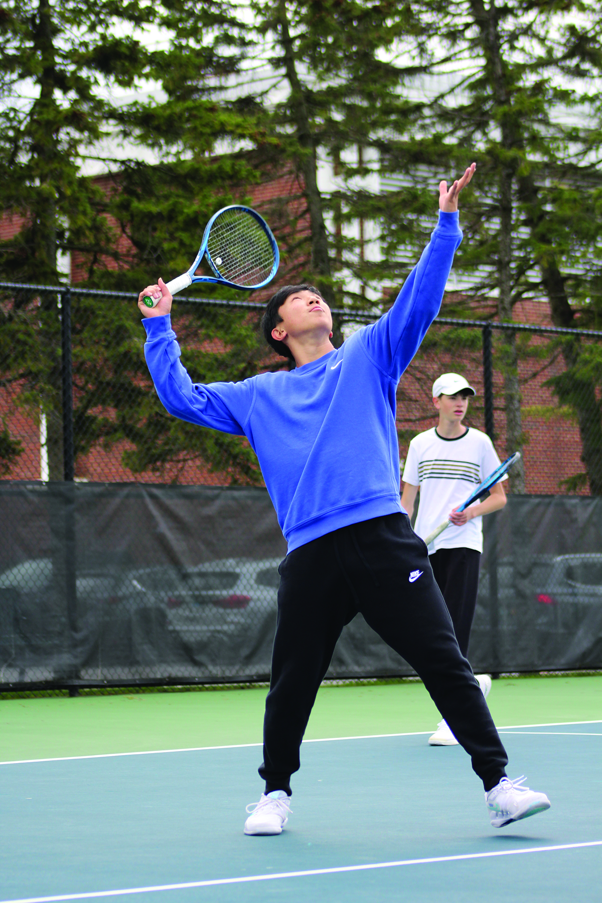 During a practice, freshman Troy Kaneshiro warms up by rallying short-court with a partner. As of May 9, Kaneshiro has a record of 14-2 in doubles matches. Photo by Jiya Sheth. 