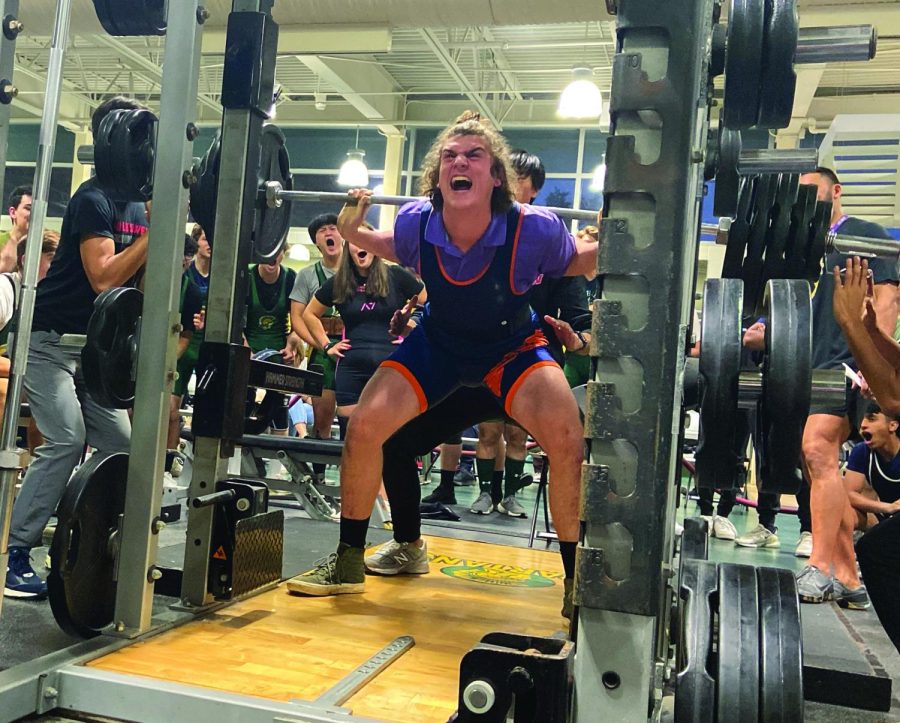 While+squatting+385+lbs.+at+a+powerlifting+meet+against+Niles+West+on+Nov.+4%2C+junior+William+Kurson+breaks+a+personal+record+and+lifts+the+top+squat+of+the+meet.+The+group+meets+two+to+three+times+a+week+to+work+on+form+and+technique%2C+but+many+members+train+daily.%0APhoto+by+Abby+Shapiro.+