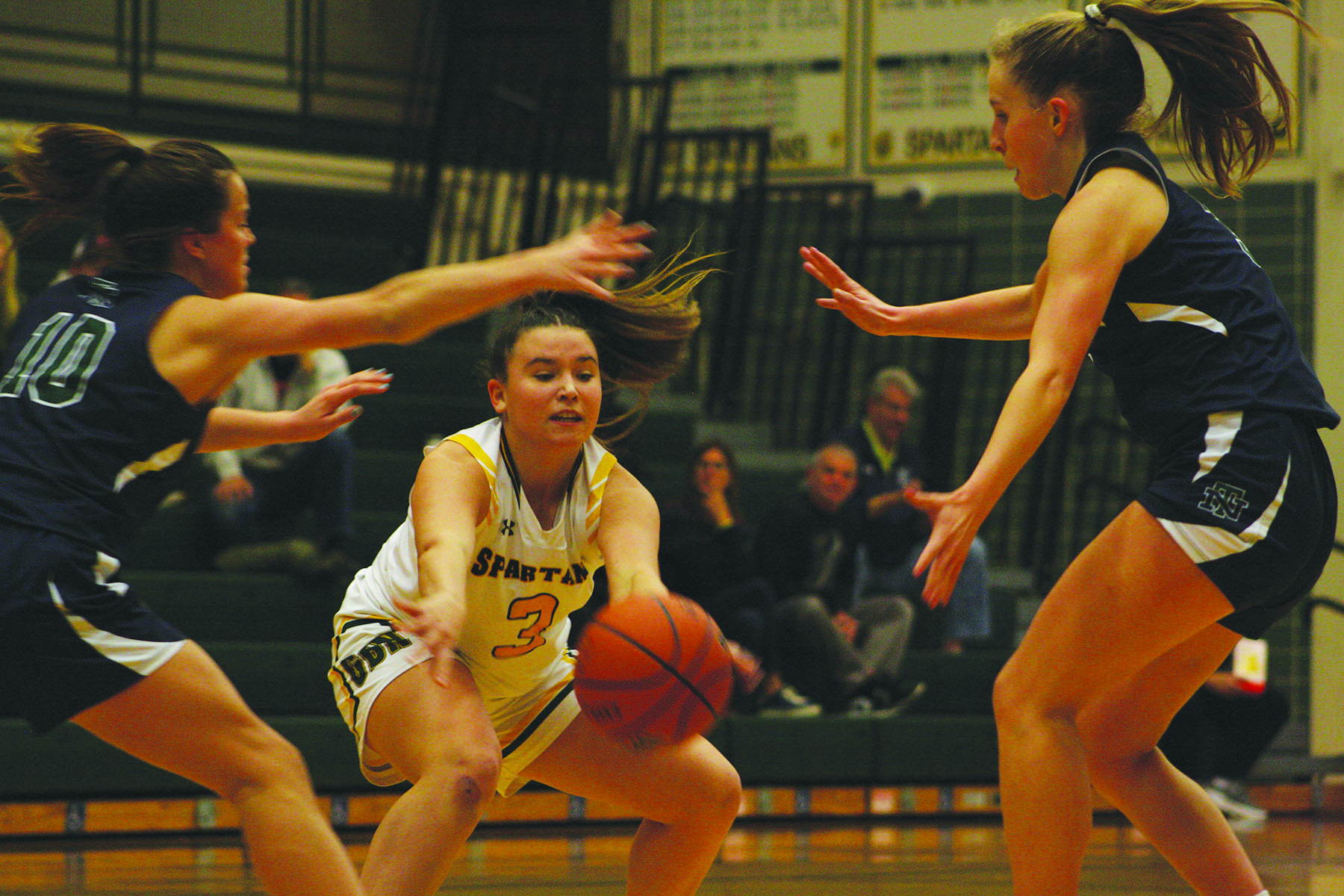 Junior Grace Gertner (middle) passes during a game against New Trier on Dec. 6. Glenbrook North won 54-40 and as of Dec. 8, the team has an overall record of 7-1 and 2-1 in conference. 