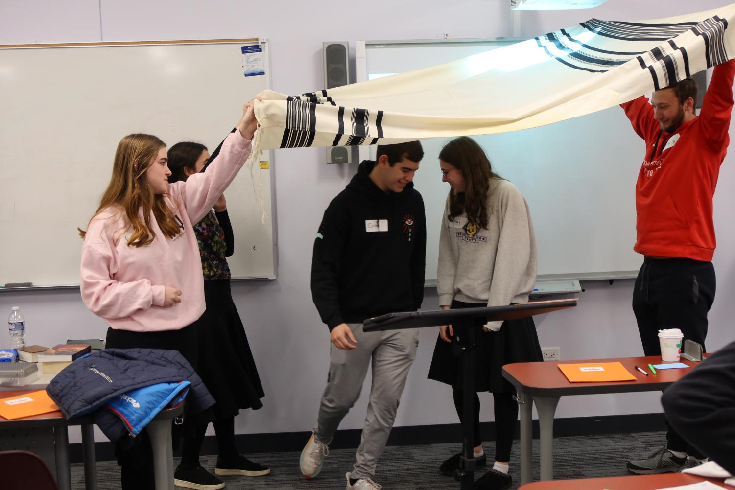 Teens demonstrate a Jewish wedding on Nov. 20 as a part of Student to Student, a program teaching teens to combat antisemitism by presenting to schools mainly in areas with low Jewish populations. Photo by Noah Kaufman