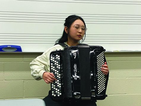 Practicing after school in the orchestra room, sophomore Lilian Shen plays a piece on her accordion. For her accordion championship, Shen and her orchestra practiced for more than 12 hours each day. Photo by Abby Shapiro.