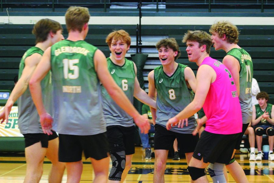 After losing the first set 25-14, members of the boys volleyball team celebrate scoring during the second set in a game against York on May 5. The team lost this game at the Northside Classic Invite 2-0 but won the other two against Libertyville and Lake Forest later that night. Photo by Abby Shapiro