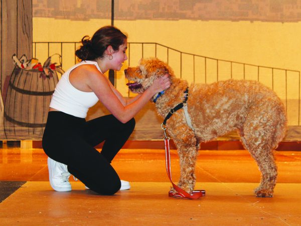 While at rehearsal for Annie, sophomore Noa Levin sings Tomorrow to Benji Shaw who plays Annies dog, Sandy. Levin stars as Annie in both casts. The play opened yesterday and is scheduled to run through tomorrow. Photo by Nicole Rogoff
