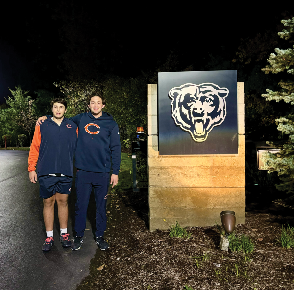 Seniors Aaron Marks (left) and Landon Lauter pose outside of Halas Hall in Lake Forest after working at Soldier Field on Oct. 22. Marks and Lauter arrived at Halas Hall at around 5:30 a.m. and returned around 7 p.m. 