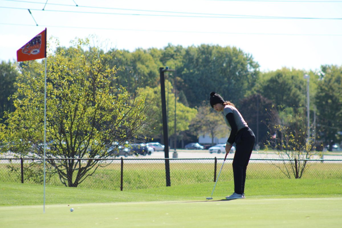 Junior Alexis Myers makes a putt downhill for a birdie during her second round at state. Myers shot a 153 overall at state, and on the second round, she shot a 76. Photo by Euben Ko