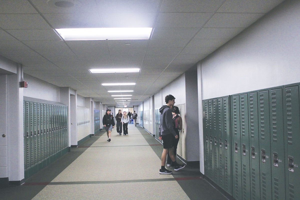 Students walk through the upstairs hallway which used to display flags above its lockers. All flags were taken down after a student ripped a Palestinian flag off of the wall.