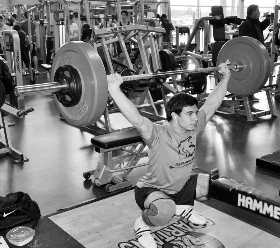Senior Matt Brown practices a snatch lift in the fitness center on Jan. 9. Brown plans on competing in the Junior Nationals Weightlifiting Competition in Foster City, Calif. in Feb.