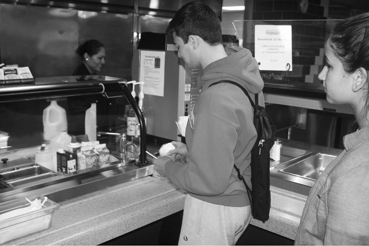 Students wait in line at the drink stand in the cafeteria during lunch. Sophomore Callie Williams used to frequent the drink stand for coffee, which offers a variety of caffeinated drinks. Photo by Morgan Berg