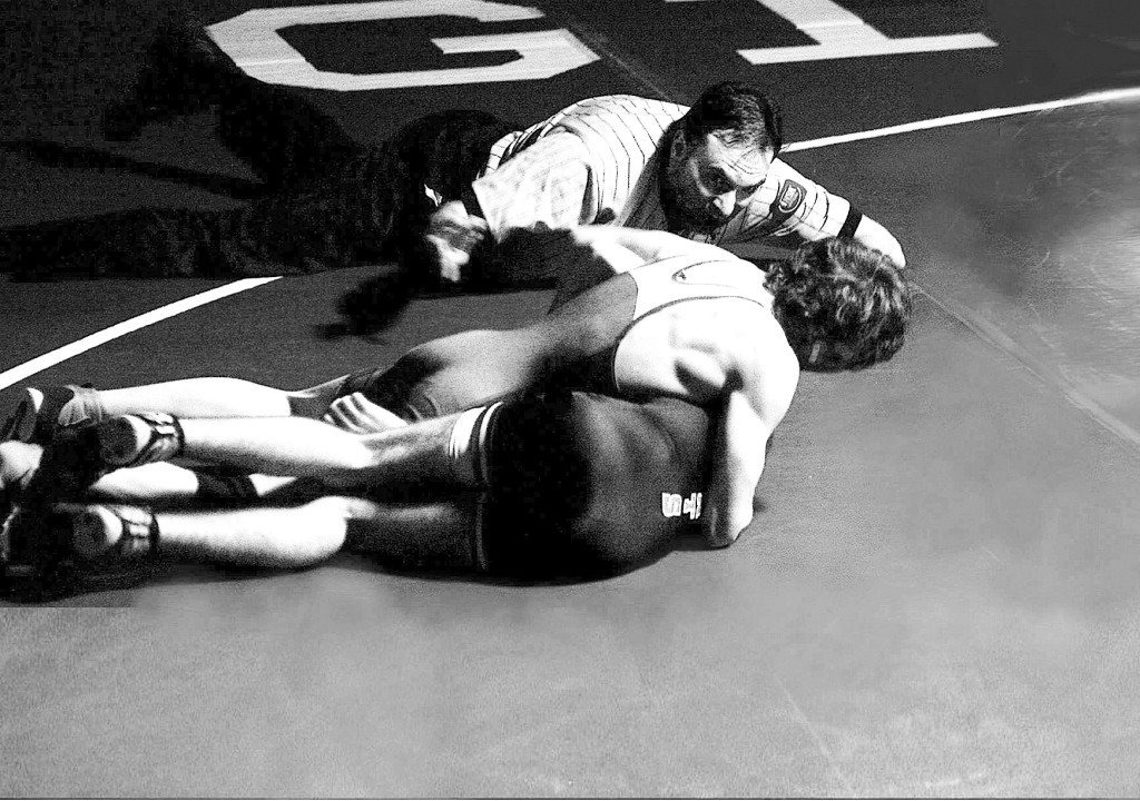 Junior Brandon Lopez holds down a Highland Park wrestler. The Spartans lost 58-16 to the Giants on Jan. 16. Lopez and teammate Vince Agins placed second at the Glenbard West Inivite on Jan. 10.