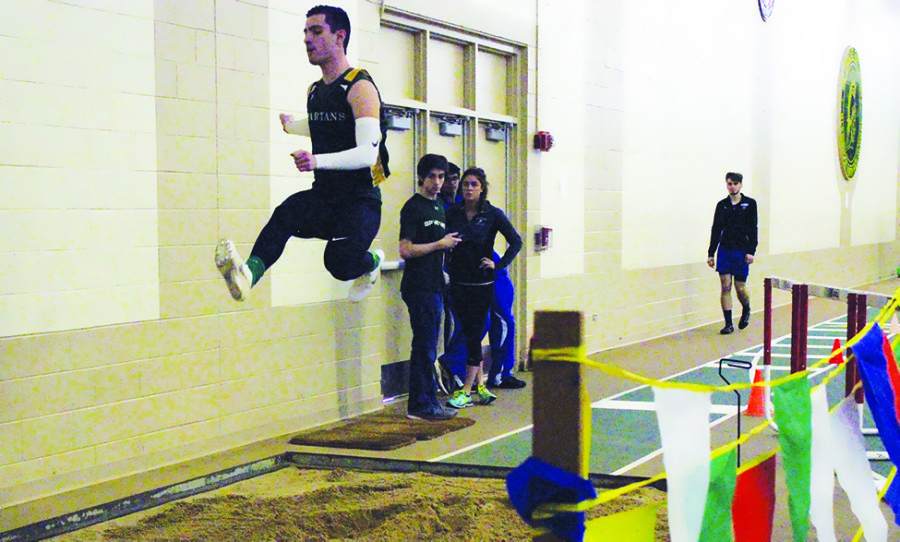 Senior Michael Papper long jumps at the indoor conference meet on March 18. Papper jumped 22’4.75” and finished in first, helping the team secure first place. Photo by Hailey Koretz