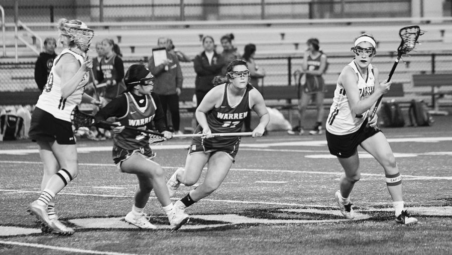 Senior+Naomi+Lutz+%28right%29+plays+offense+in+the+girls+lacrosse+game+against+Warren+Township+on+May+14.+Next+year%2C+she+plans+to+attend+the+Massachusetts+Institute+of+Technology+as+a+lacrosse+commit.+Photo+by+Richard+Chu.